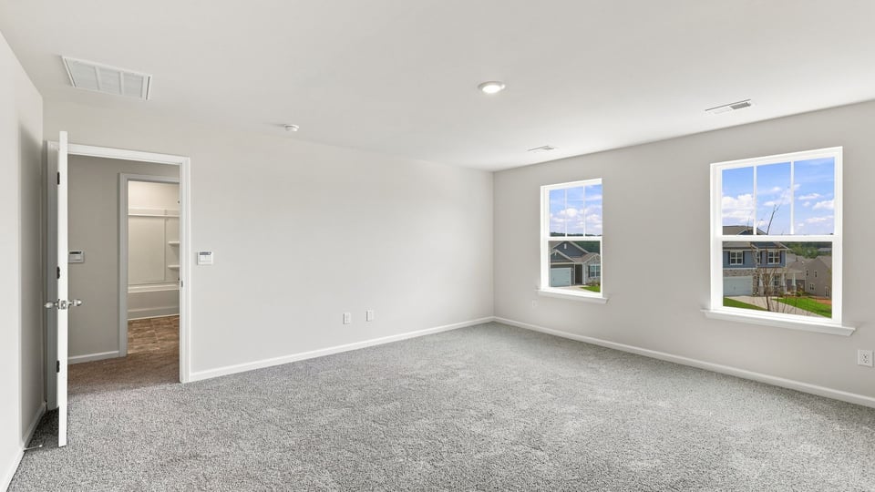 Bedroom with carpet and window.