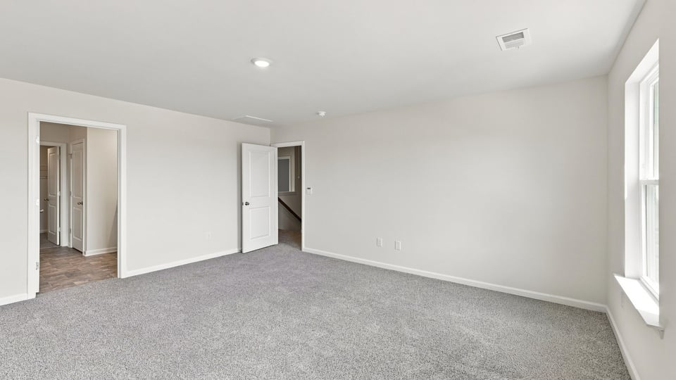 Bedroom with carpet and window.