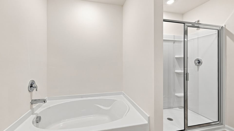 Bathroom with bathtub and walk in shower.