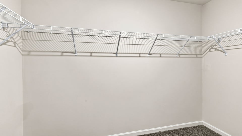 Closet with hanging storage racks.