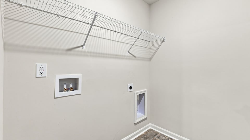 Laundry room with hanging storage racks.