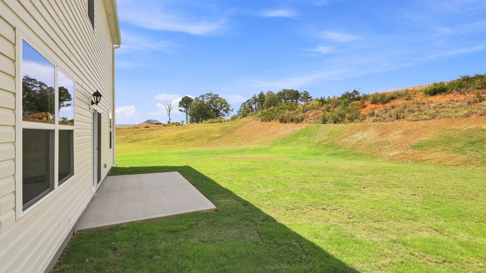 Back exterior of home with patio.