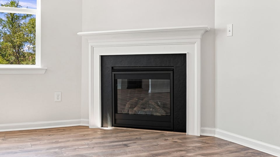 Living room with window and fireplace.