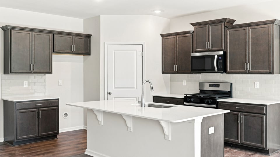 Kitchen with island and cabinets.