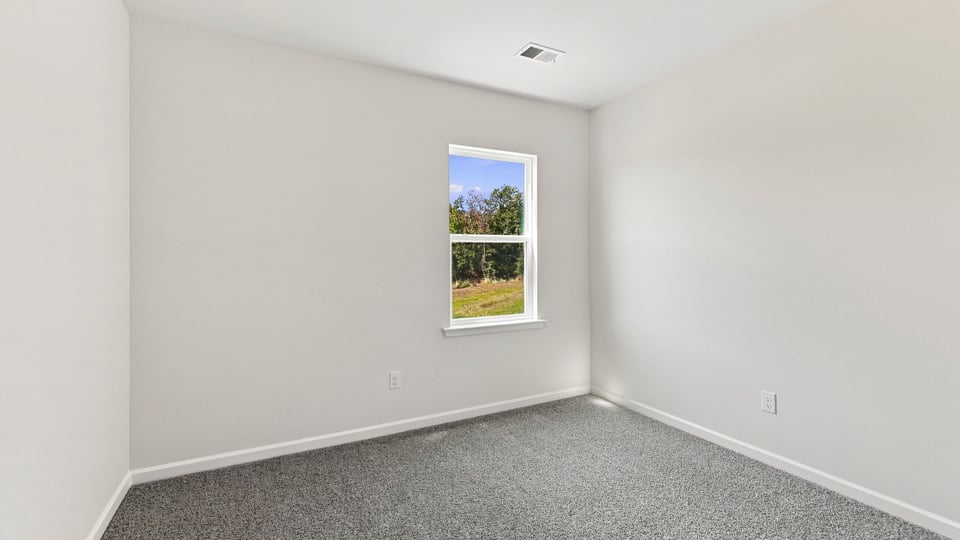 Bedroom with carpet and windows.