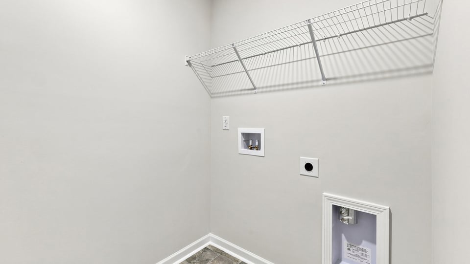 Laundry room with shelf.
