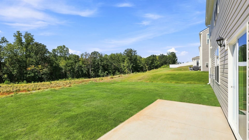 Back exterior with large backyard.