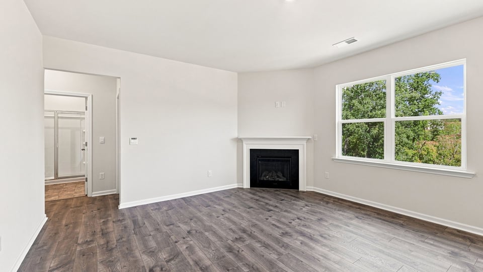 Living room with windows and fireplace.