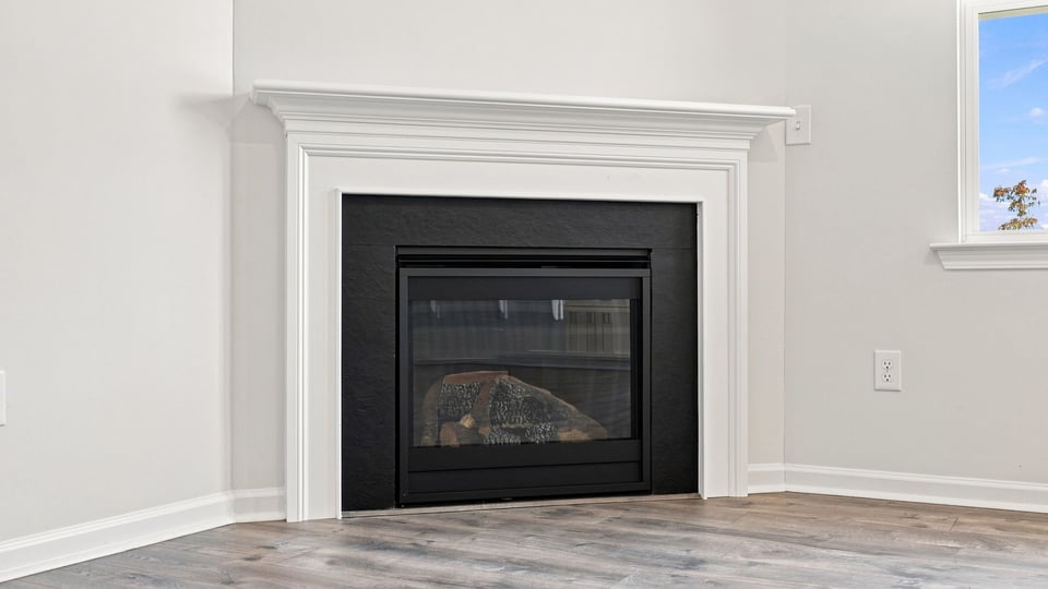 Living room with windows and fireplace.