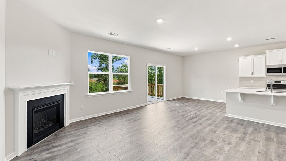 Living room with windows and fireplace.