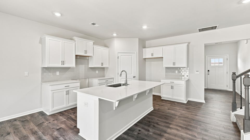 Kitchen and island with quartz countertops.