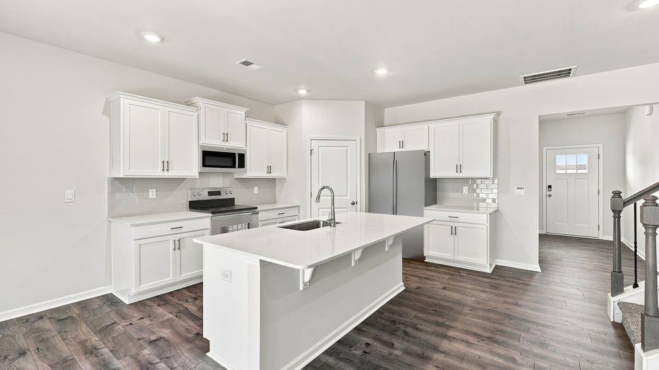 Kitchen and island with quartz countertops.