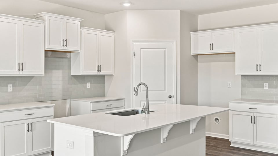 Kitchen and island with quartz countertops.