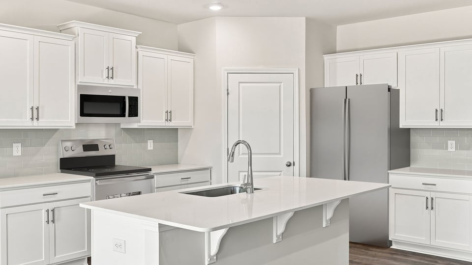 Kitchen and island with quartz countertops.