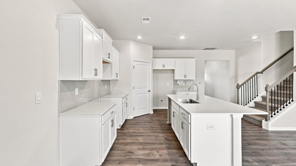 Kitchen and island with quartz countertops.