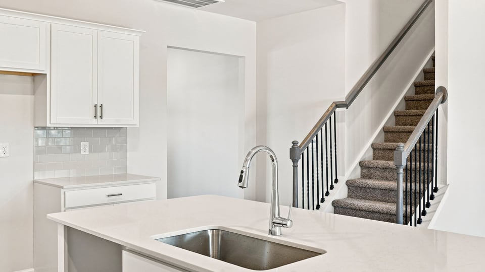 Kitchen and island with quartz countertops.