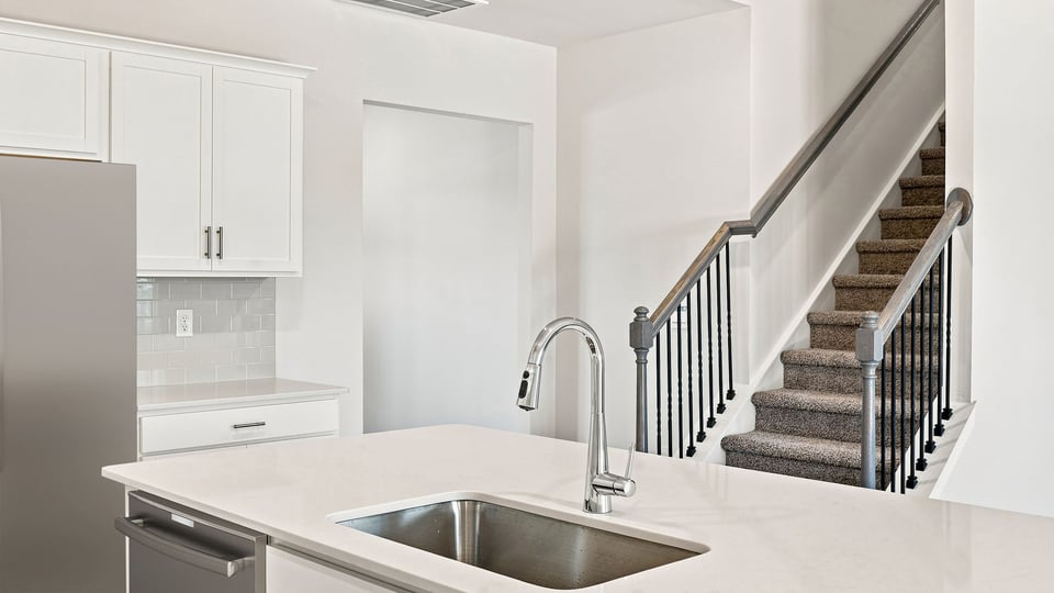 Kitchen and island with quartz countertops.