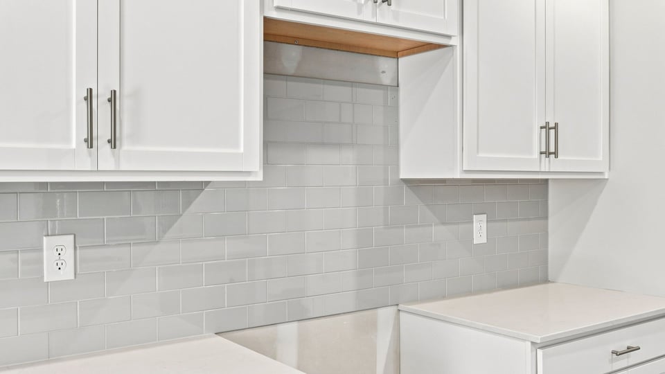 Kitchen and island with quartz countertops.