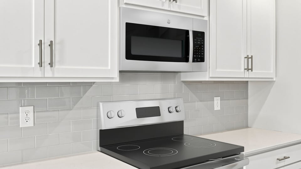 Kitchen and island with quartz countertops.