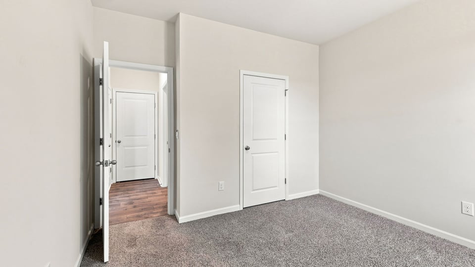 Bedroom with carpet and window.