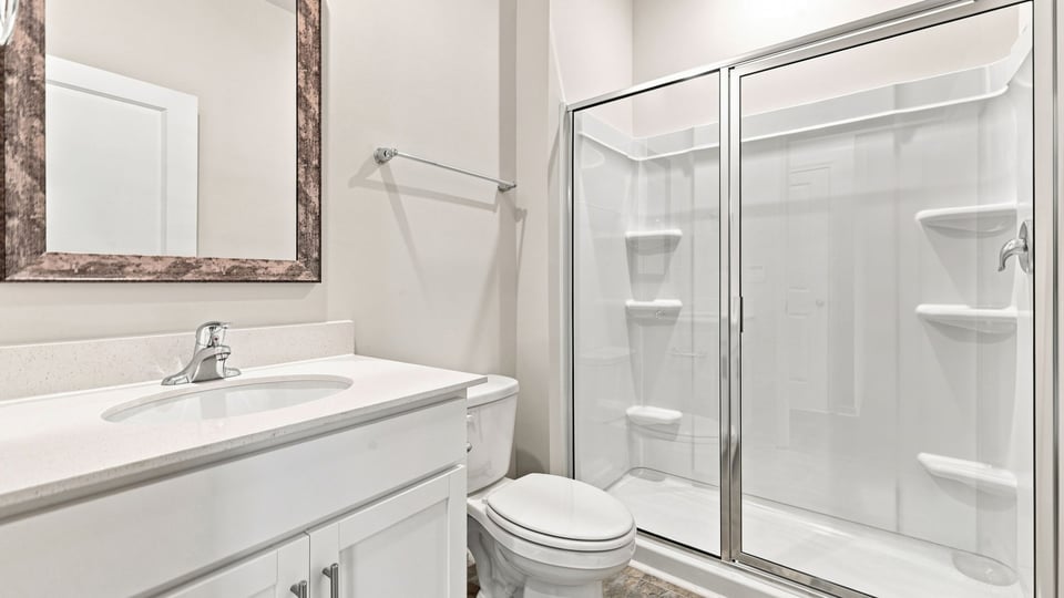 Bathroom with single vanity sink and walk in shower.