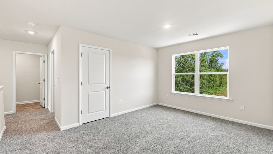 Bedroom with carpet and window.