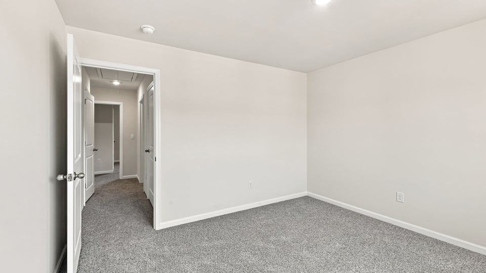 Bedroom with carpet and window.