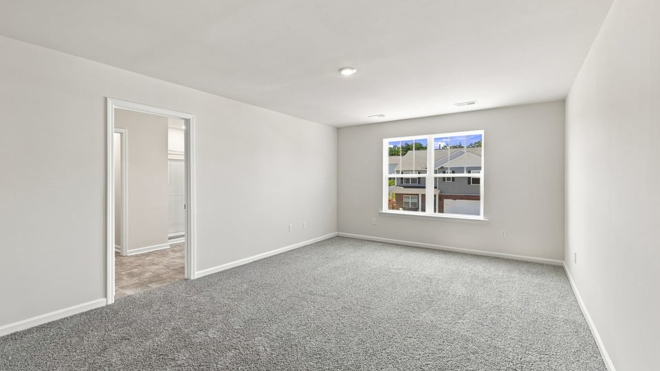 Bedroom with carpet and windows.