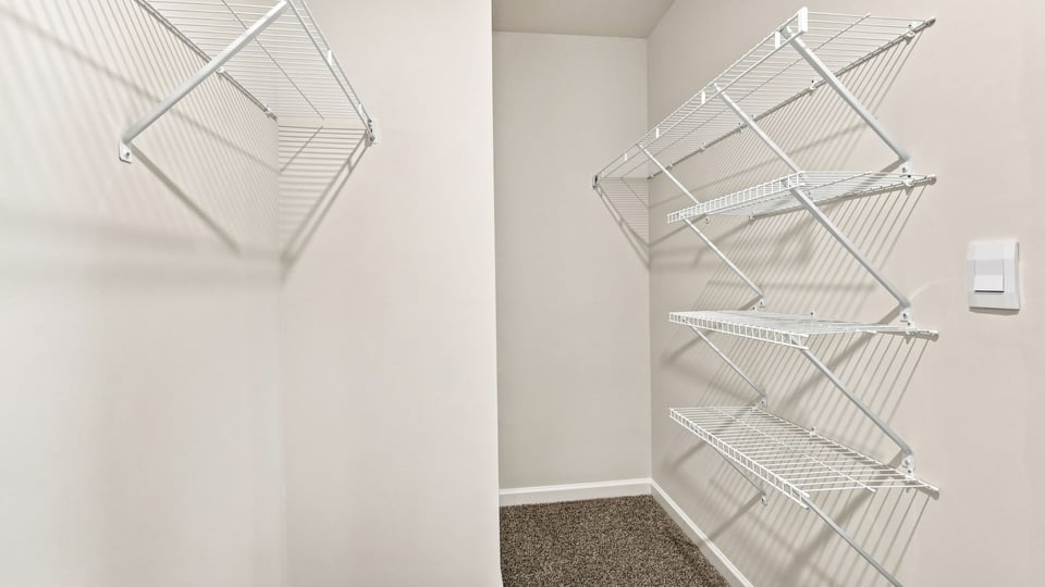Closet with hanging storage racks.