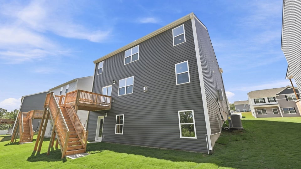 Back exterior of home with large backyard.