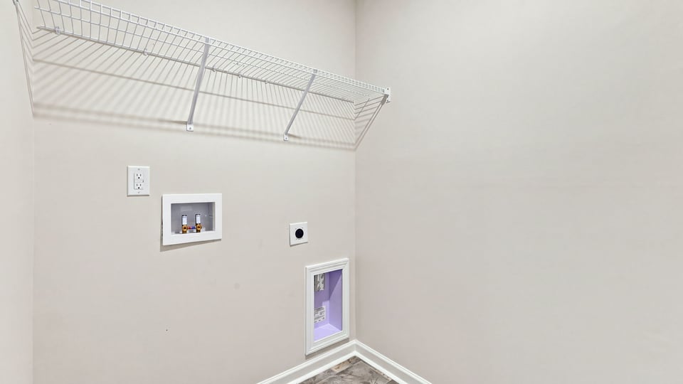 Laundry room with hanging storage racks.