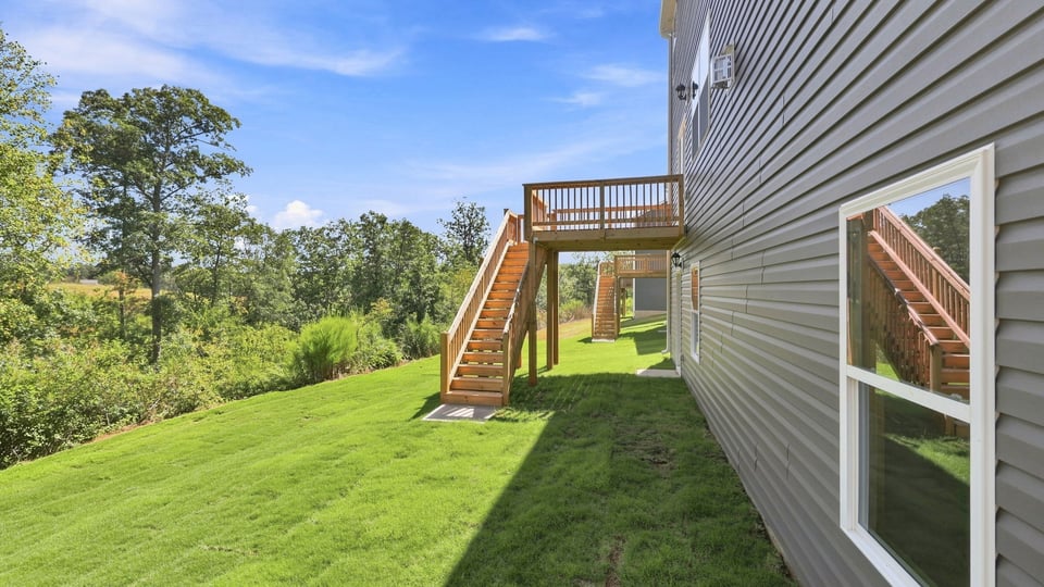 Back exterior of home with large backyard.