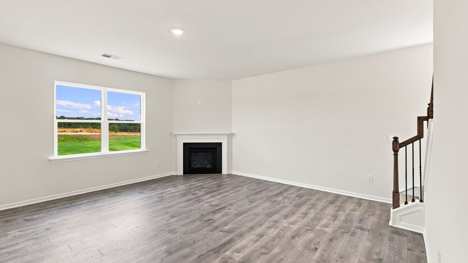 Living room with windows and fireplace.