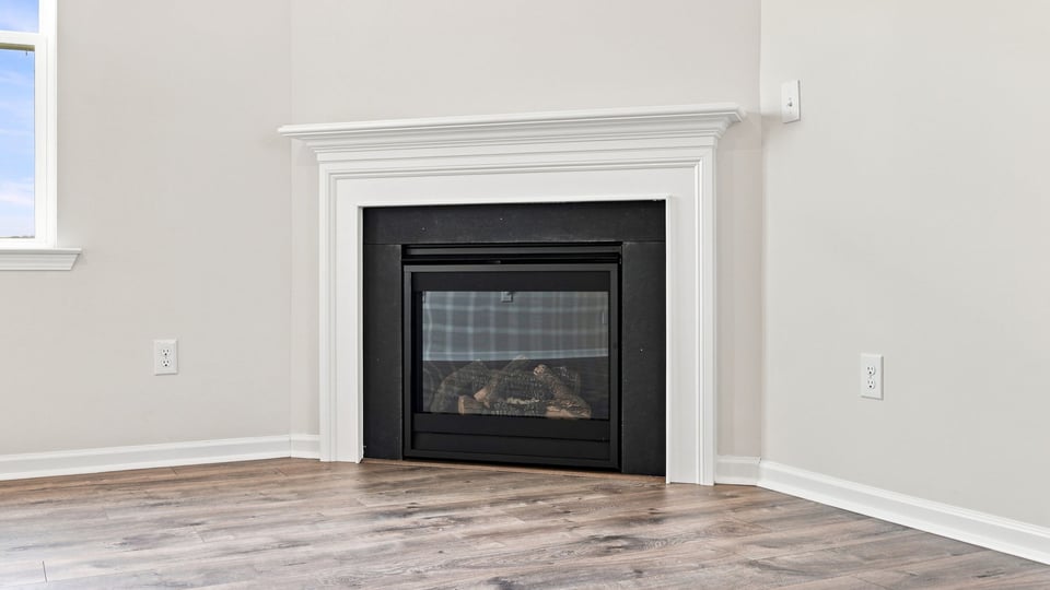 Living room with windows and fireplace.