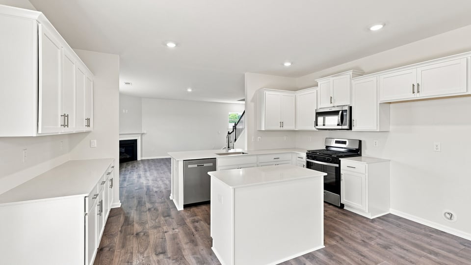 Kitchen and island with quartz countertops.