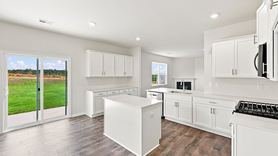 Kitchen and island with quartz countertops.