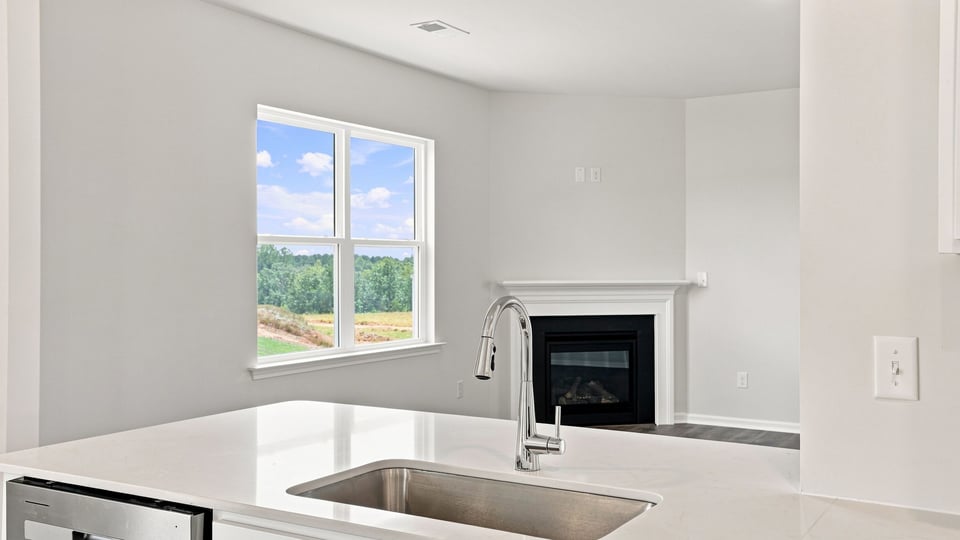 Kitchen and island with quartz countertops.