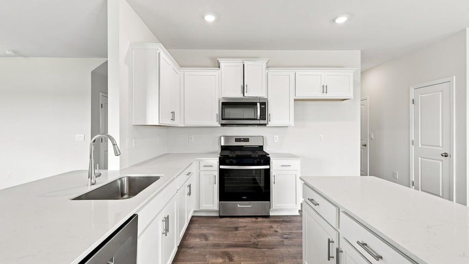 Kitchen and island with quartz countertops.