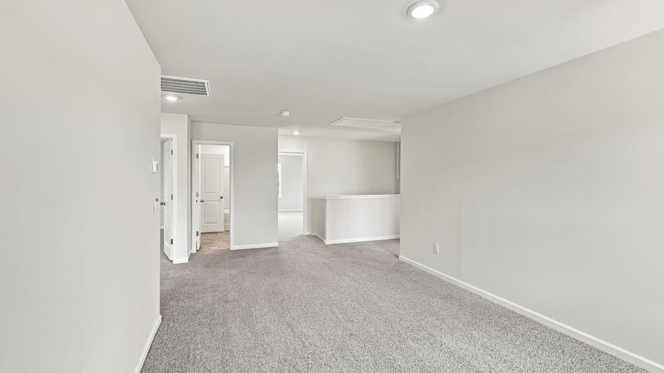 Loft area with carpet.