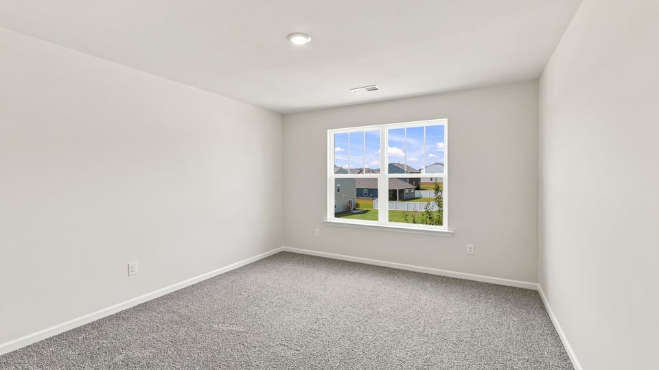 Bedroom with carpet and window.