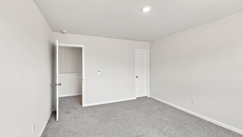 Bedroom with carpet and window.