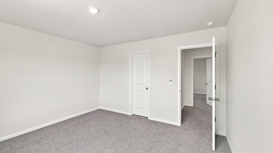 Bedroom with carpet and window.