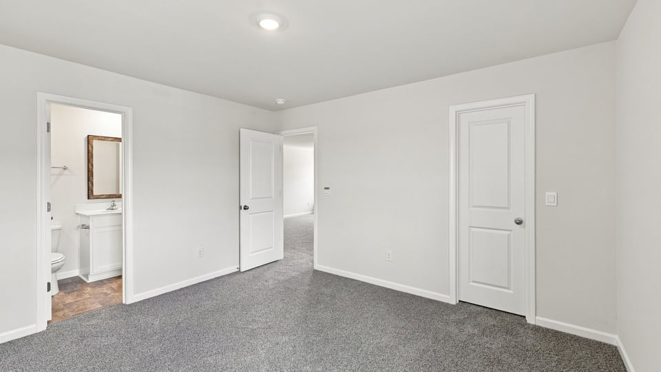 Bedroom with carpet and window.
