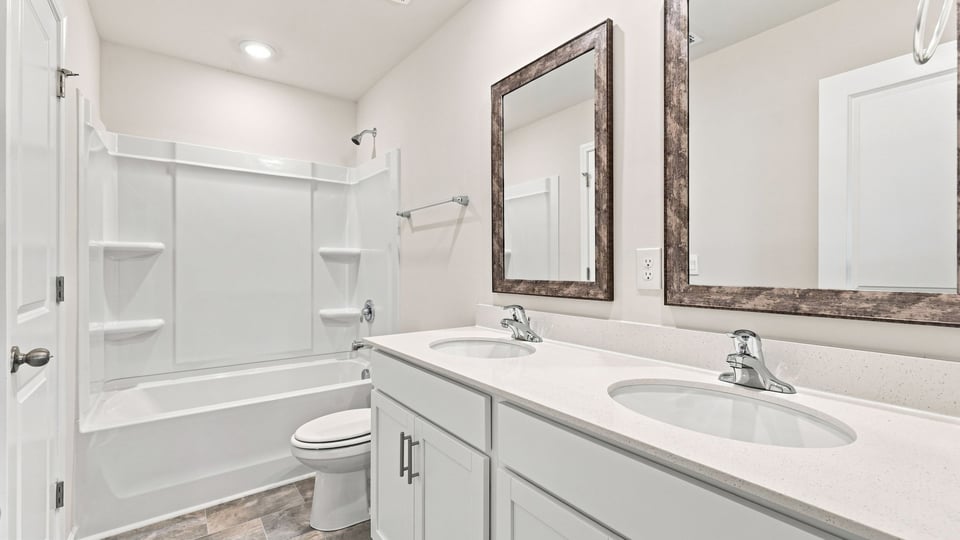 Bathroom with double vanity sink and bathub
