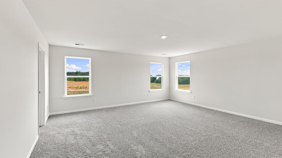 Bedroom with carpet and window.