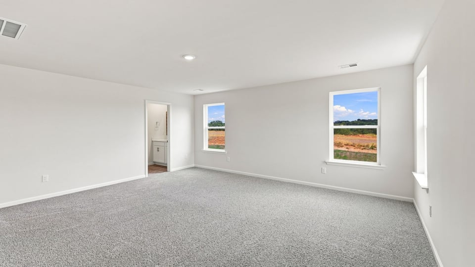 Bedroom with carpet and window.