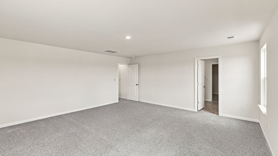 Bedroom with carpet and window.