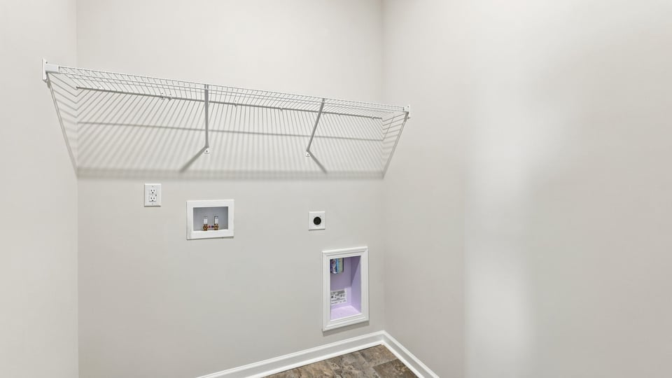 Laundry room with hanging storage racks.