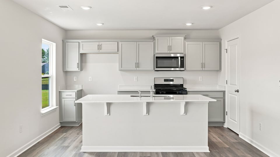 Kitchen and island with quartz countertops.