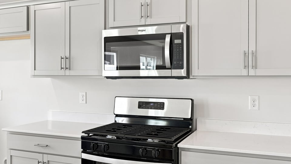 Kitchen and island with quartz countertops.